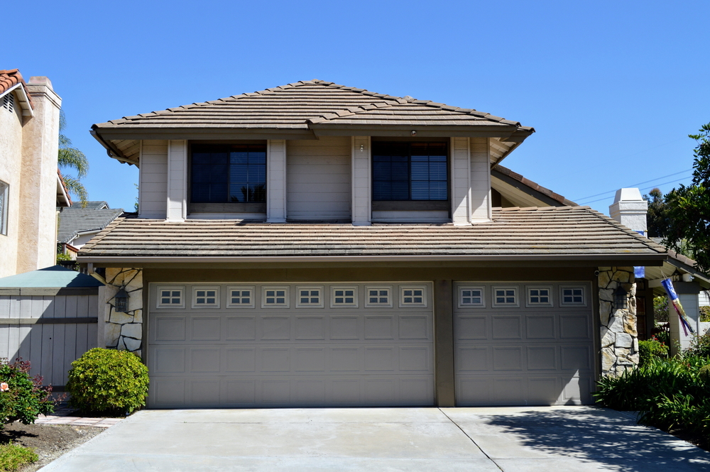 Two-Story Suburban Home with Three-Car Garage – JP Buys SD Front exterior view of a two-story suburban house featuring a large three-car garage and landscaped yard – JP Buys SD