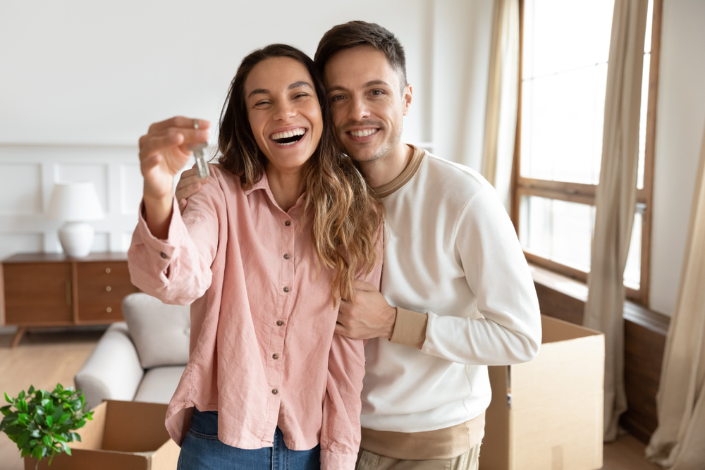 Excited Couple Holding Keys After Home Sale – We Buy Houses Vista Happy couple smiling and holding house keys in their new home after a fast property sale in Vista, California – We Buy Houses Vista